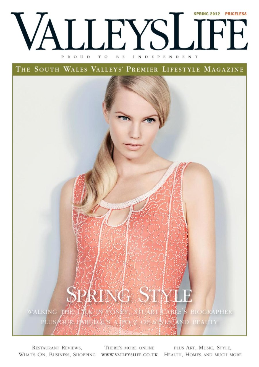 Valleys Life Spring 2012 cover. A model with long blonde hair swept over one shoulder wears a coral beaded sleeveless top with a scalloped neckline, photographed against a plain pale grey background. Headline: Spring Style.